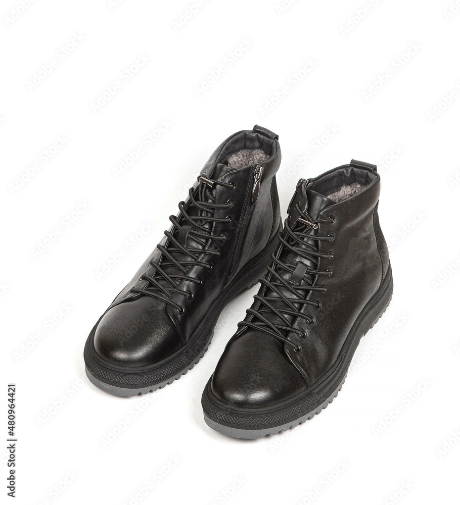 Men black winter leather boots with fur inside isolated on white background Men black winter leather boots with fur inside isolated on white background