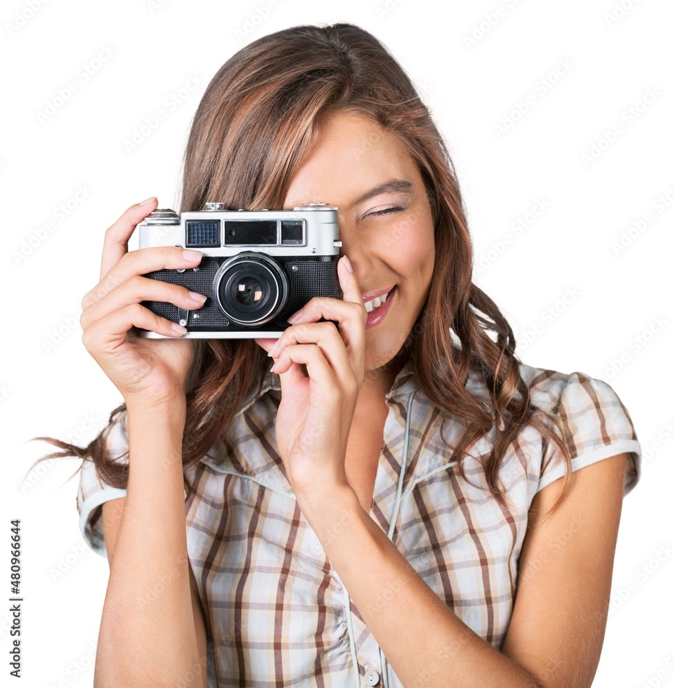 Portrait of the young female photographer with a vintage film camera. Portrait of the young female photographer with a vintage film camera.