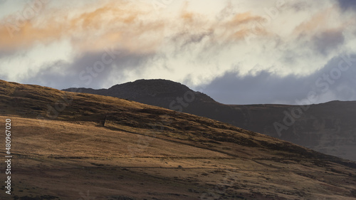 British mountain landscape at dawn with split coloured cloudscape