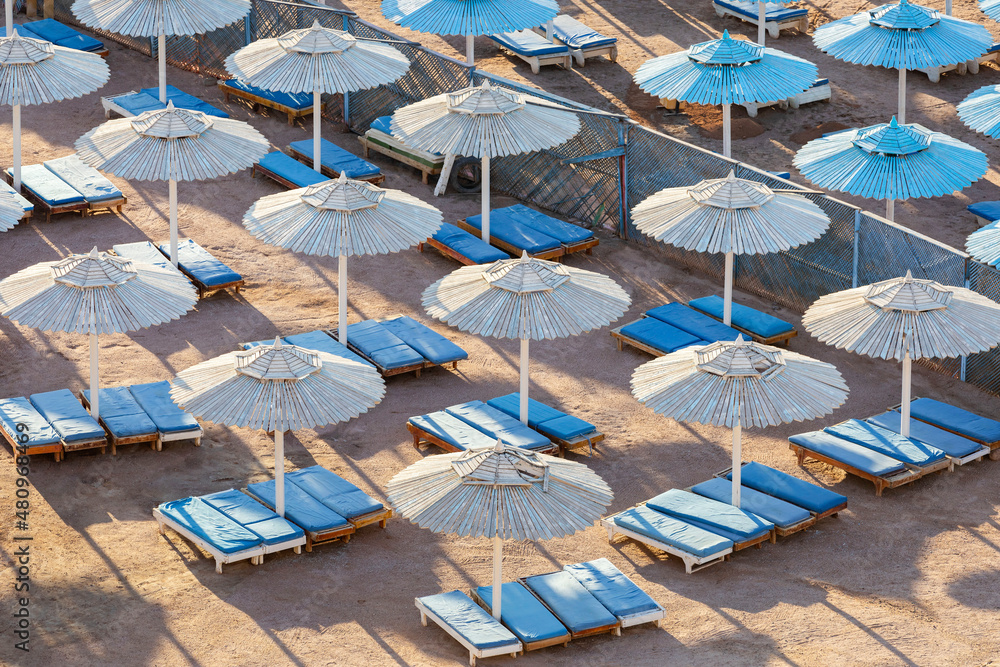 Egypt. Sharm el-Sheikh. Beach umbrellas from the sun and sun loungers on the beach.