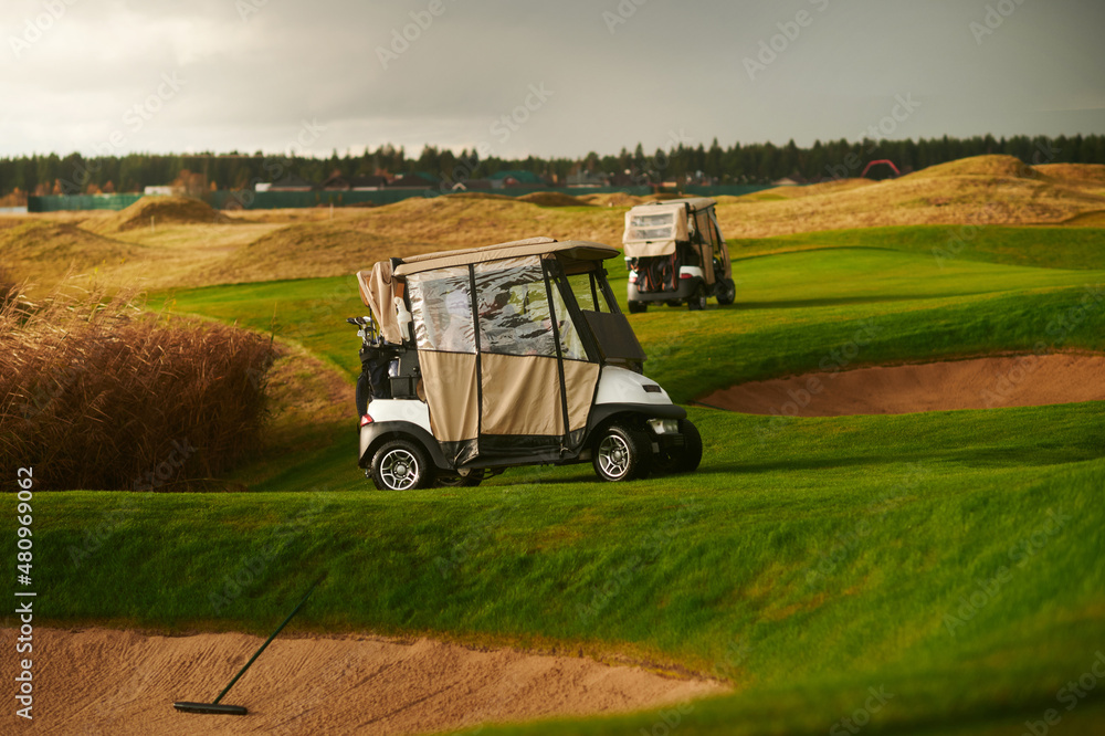Fototapeta premium Two golf carts for golf on the course