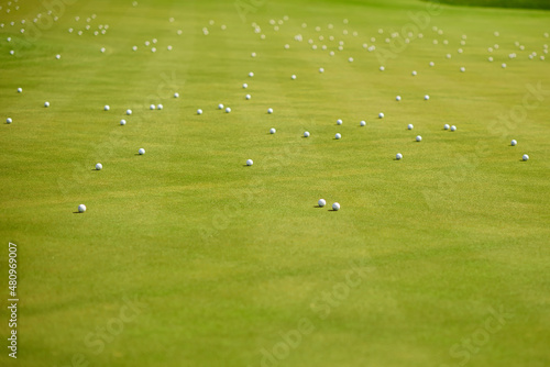 many golf balls on green