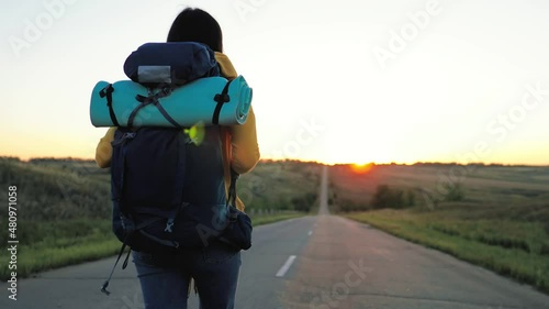 Wallpaper Mural Concept of traveling. Woman hiking in mountains enjoying success. Rear view of female hipster walking along rocky area on sunset. Modern person with backpack. Hiking walking slow motion activity. Torontodigital.ca