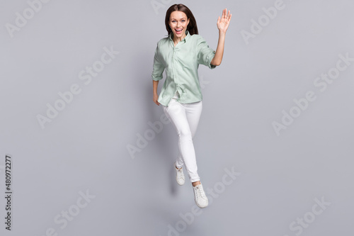 Full body photo of nice brunette lady run wave wear blouse trousers shoes isolated on grey color background