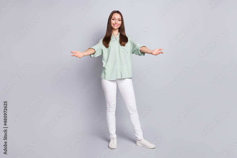 Full size photo of cute brunette lady hug wear blouse trousers sneakers isolated on grey color background