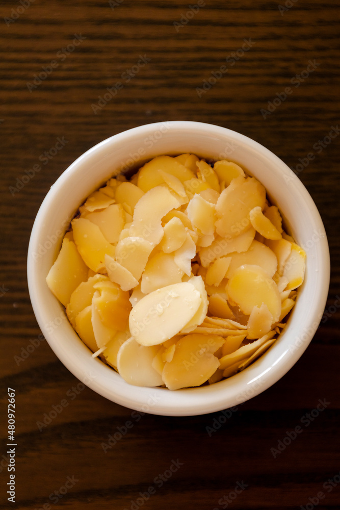 small bowl with filleted almonds close up small bowl with filleted almonds close up