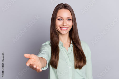 Photo of funky brunette lady give hand wear blue blouse isolated on grey color background