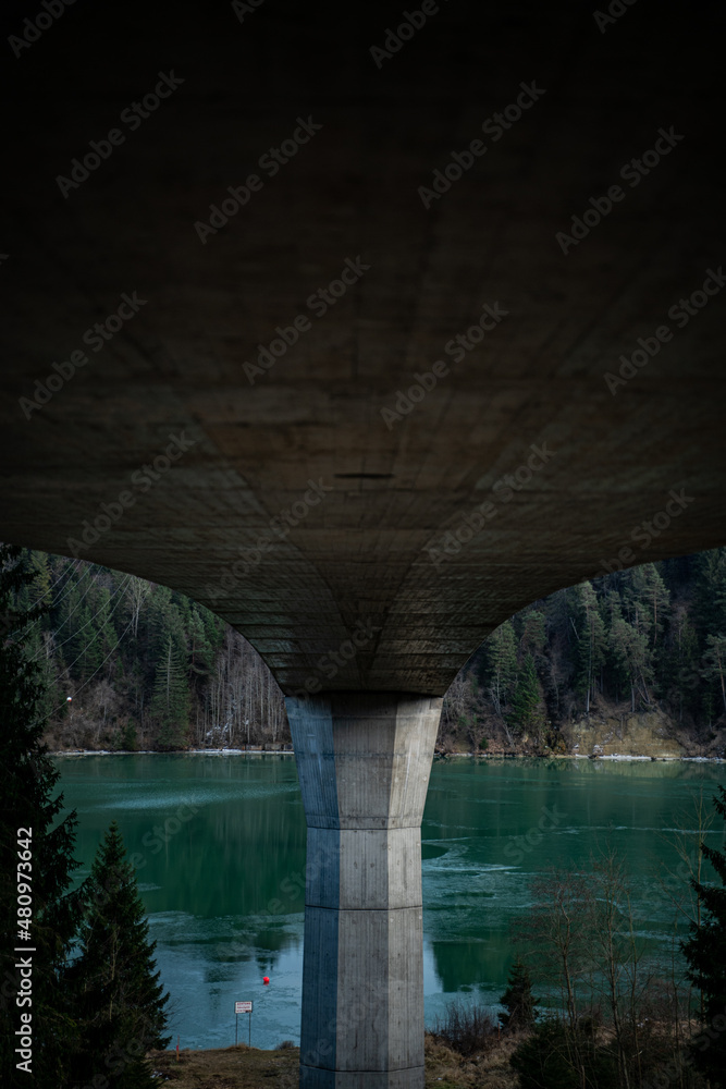 Bridge over turquoise water and overcast sky