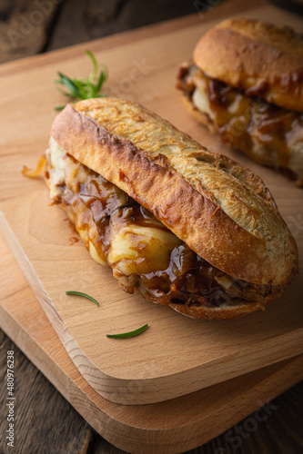 Pulled pork sandwich with melted cheese and BBQ sauce