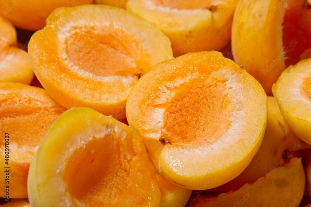 Close-up of apricot halves. Background or texture of summer fruit Close-up of apricot halves. Background or texture of summer fruit