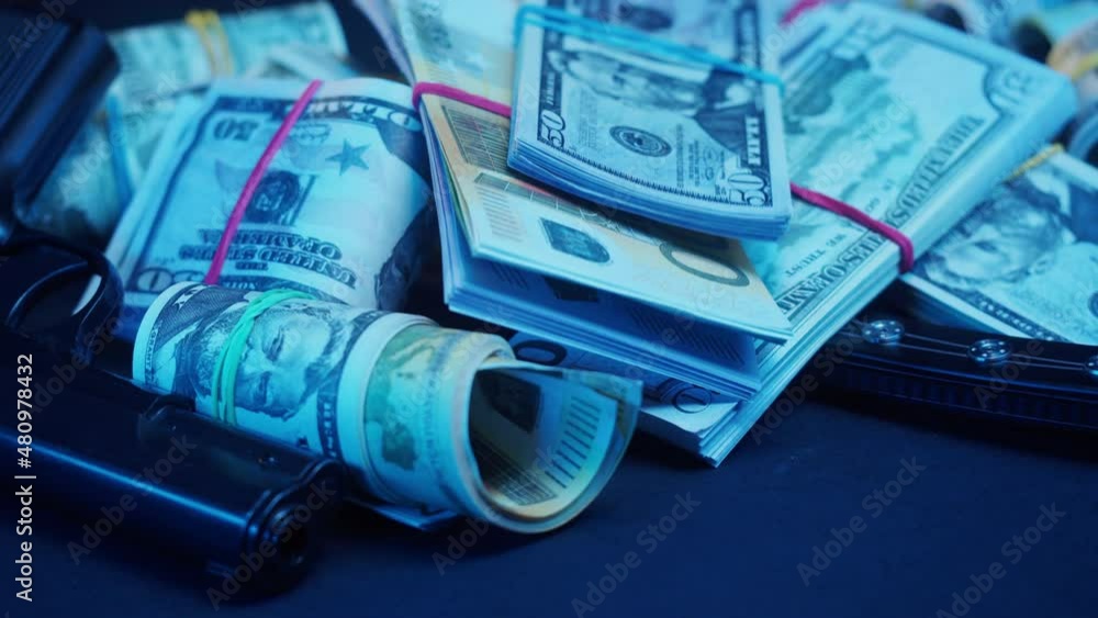 Throwing money cash close-up. Euro and dollar banknotes with gun on black background. Crime and theft concept. Throwing money cash close-up. Euro and dollar banknotes with gun on black background. Crime and theft concept.
