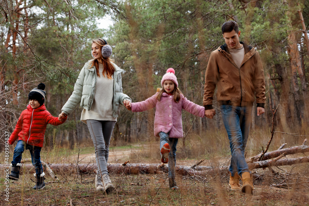 Happy family spending time together in forest Happy family spending time together in forest