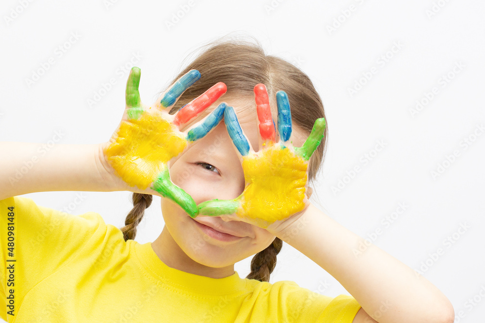 Happy cute little girl with colorful painted hands isolated on a white education concept Happy cute little girl with colorful painted hands isolated on a white education concept