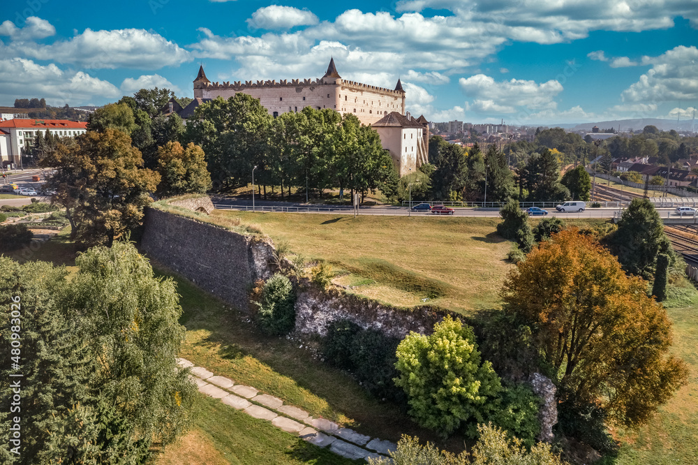 Aerial panorama view of Zvolen medieval castle with turrets and outer bastion fortification in Slovakia blue cloudy sky background