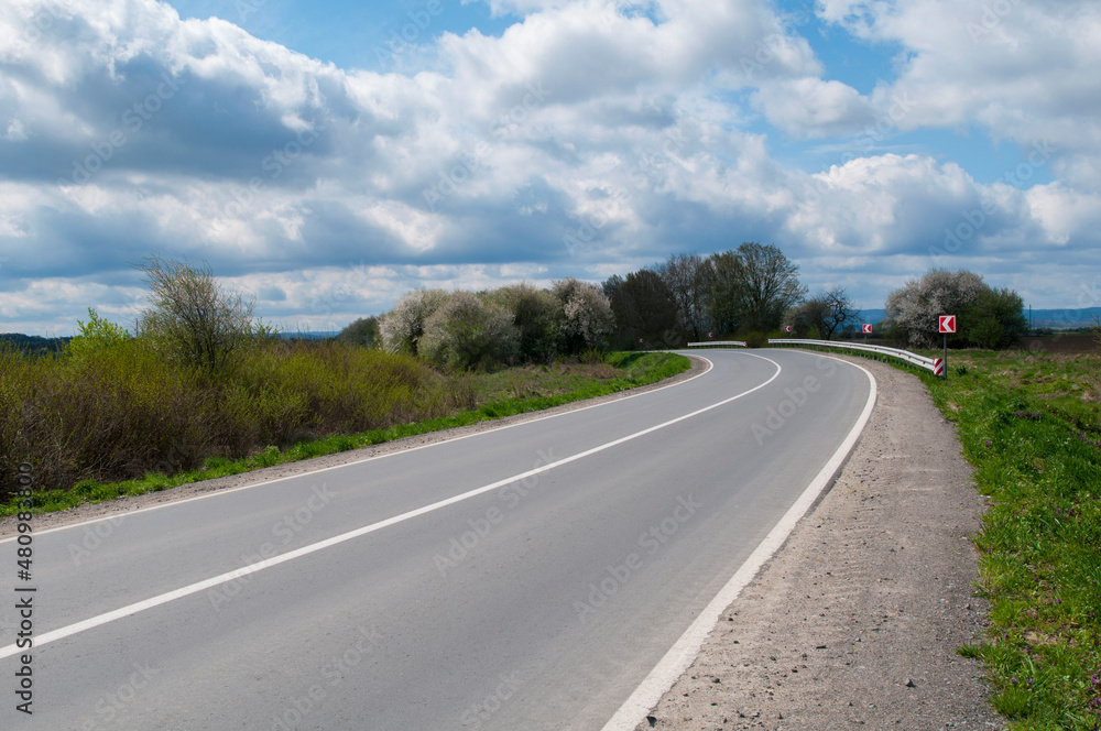 highways in the mountains against the background of the sunny sky and the white clouds