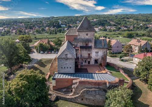Aerial view of medieval Gothic Simontornya castle protecting the cross on the Sio river  in Tolna county Hungary with restored donjon, palace, brick walls blue cloudy sky photo