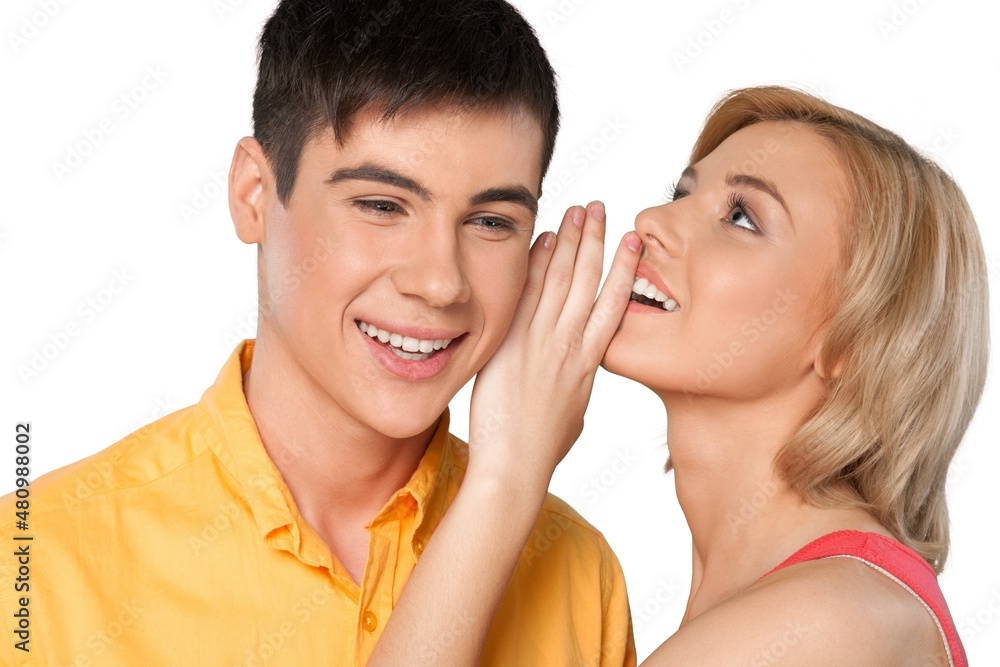 Young smile couple whispering secrets to each other Young smile couple whispering secrets to each other