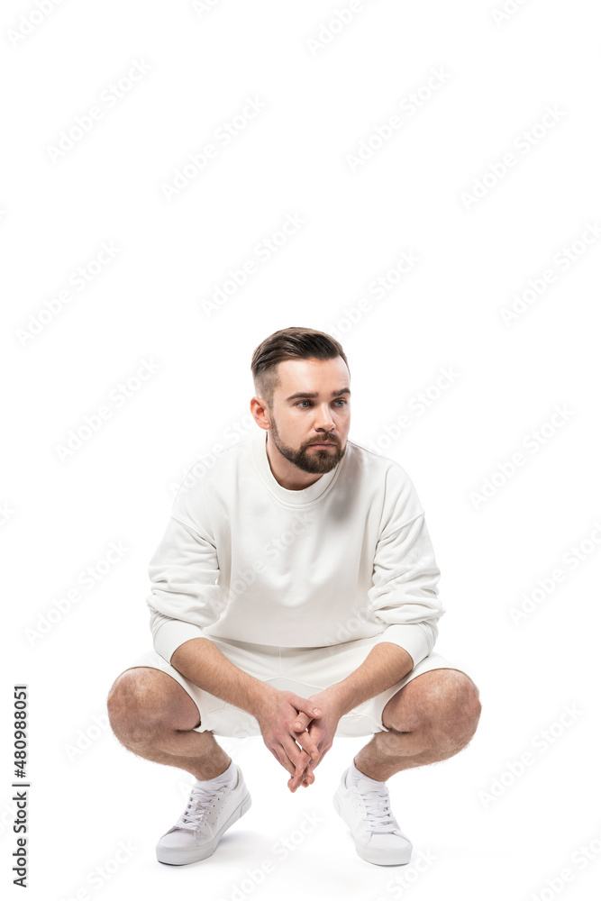 Handsome man wearing white sweatshirt and shorts on white background Handsome man wearing white sweatshirt and shorts on white background
