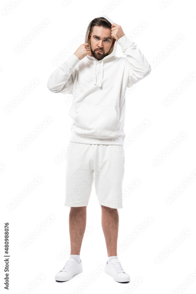 Handsome man wearing blank white hoodie and shorts on white background Handsome man wearing blank white hoodie and shorts on white background