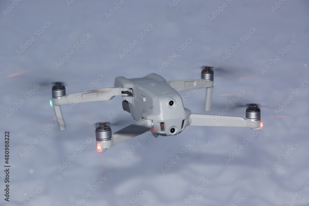 Fototapeta premium Quadcopter in flight over snow