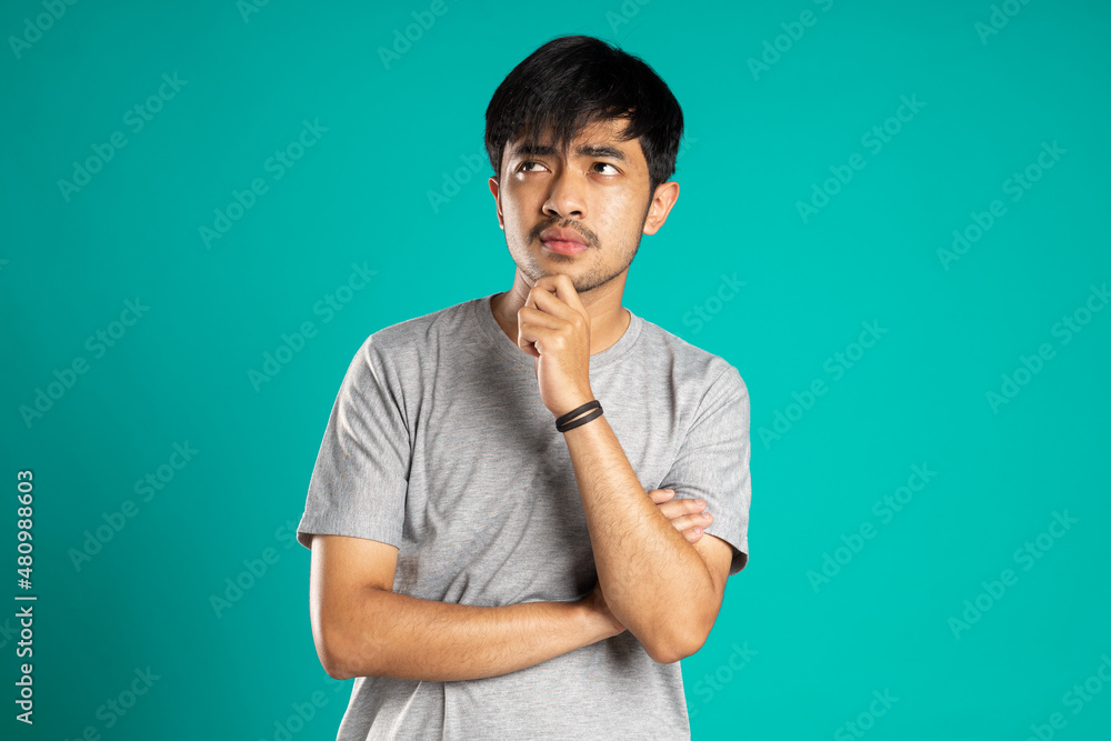 young man touch chin dream think look empty space young man touch chin dream think look empty space