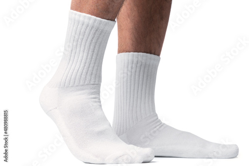 Male feet with white cotton socks on white background photo