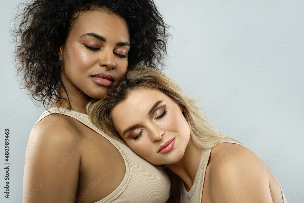 Portrait of Caucasian and African American women in studio Portrait of Caucasian and African American women in studio