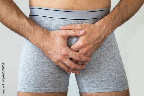 Young man suffering from penile pain