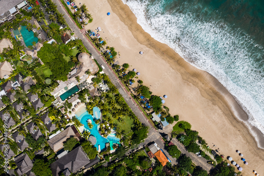 Top down view of various hotels and resorts that lines the sandy Kuta beach in Bali, Indonesia in Southeast Asia