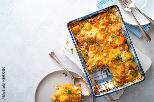 Vegetable gratin with sweet potato, celery, parsnip, carrot, cheese and eggs. Comfort, rustic one casserole food.