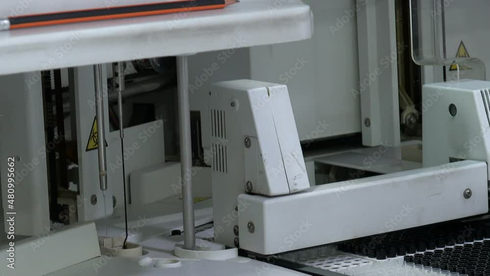 Healthcare concept. Clinical blood chemistry analyzer at work. Automated process of biological samples research in biochemistry analyzer. Professional laboratory equipment Healthcare concept. Clinical blood chemistry analyzer at work. Automated process of biological samples research in biochemistry analyzer. Professional laboratory equipment