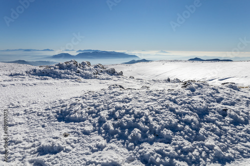 mountains of the Apennines immersed in the mist seen from the Matese mountains with snow. Monte Mutria, Matese National Park, Campania and Molise, Italy