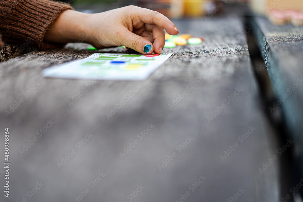 Obraz premium Little child hand playing bingo outdoors