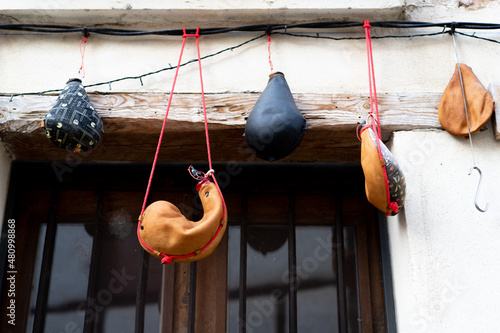 Handcrafted wineskin hanging on the facade of a wineskin shop photo