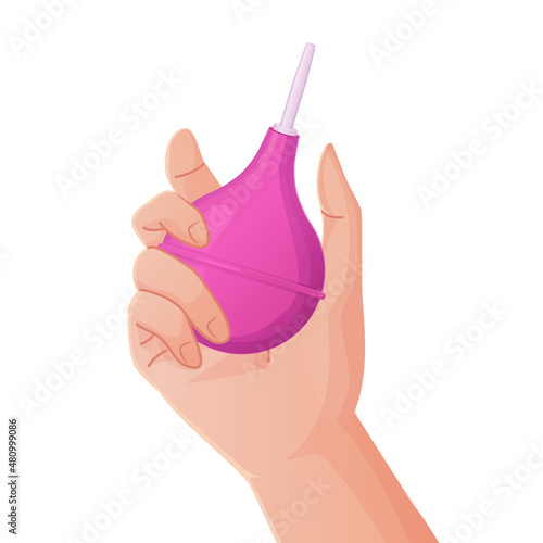 Hand holding pink rubber enema or clyster. Medical cleaning body detox tool.