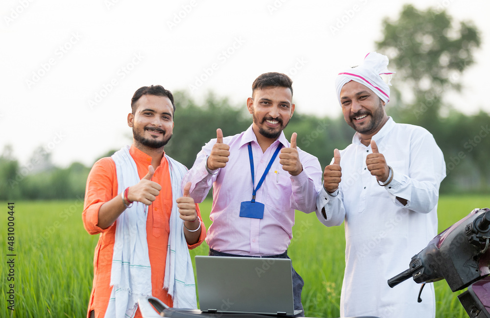 Happy farmers with banker showing thumbs up towards the camera