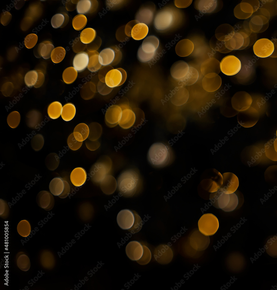 Golden yellow orange bokeh of christmas lights on black isolated background Golden yellow orange bokeh of christmas lights on black isolated background