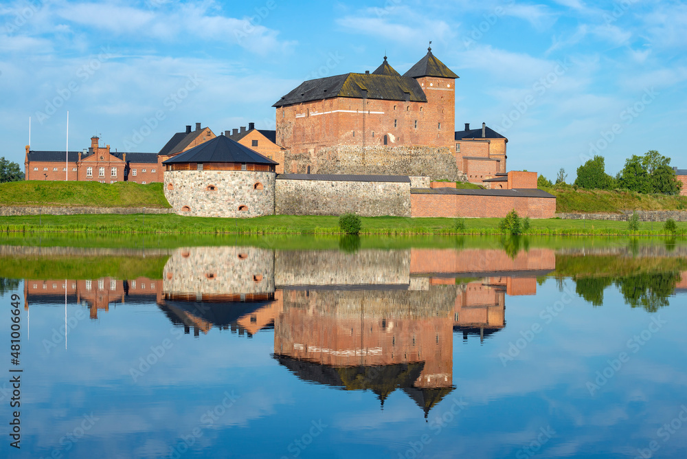 Fototapeta premium The ancient fortress of the city of Hameenlinna on the shore of Lake Vanayavesi with a reflection. Finland