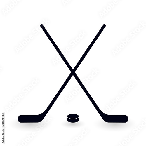 Crossed ice hockey sticks and puck. Symbol of winter game, active recreation, leisure activity. Vector illustration of hockey sticks silhouette.