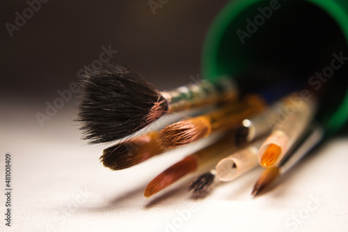 used art brushes in a pencil case close-up selective focus