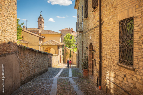 Couple walking a small alley in Castell'Arquato, Piacenza, Italy photo