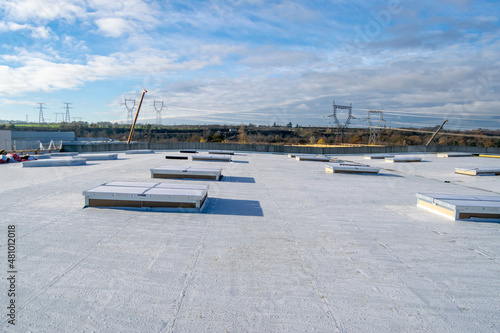 Construction of a flat roof with EPDM (ethylene propylene diene monomer) membrane on a large warehouse photo