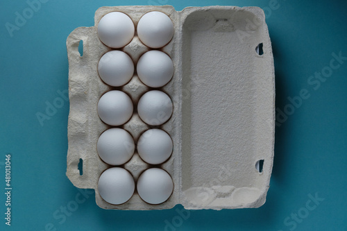 natural white eggs in a package on a blue background