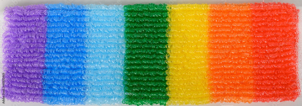Knitted multi-colored washcloth on a white background