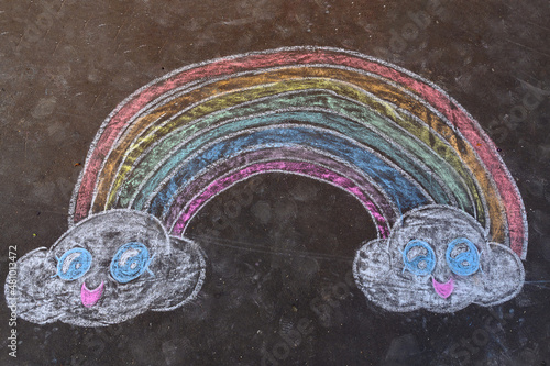 Rainbow drawn with sidewalk chalk on the ground - temporary art