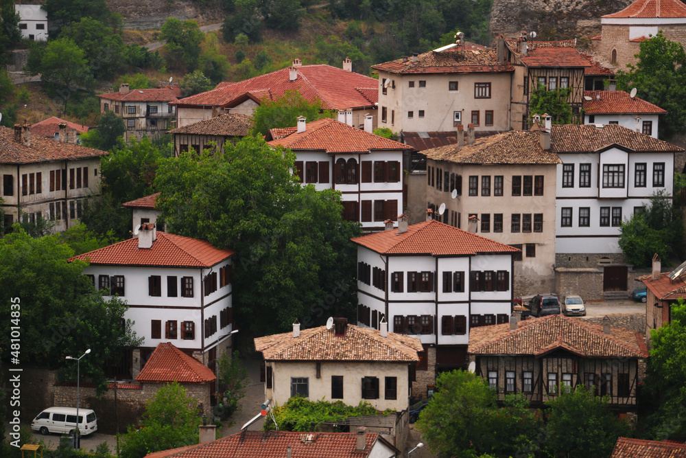 selective focus, old historical stone houses in Safranbolu, the old historical district of Karabük district. red roof tile. Turkish flag hanging in stone house