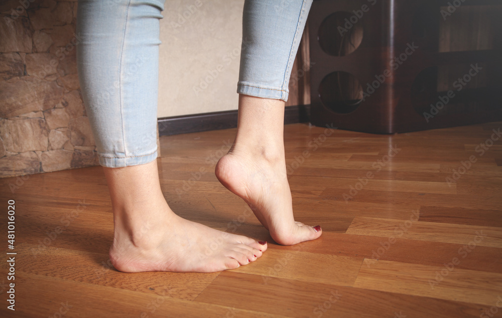 Female feet walking on floor at home. Female feet walking on floor at home.