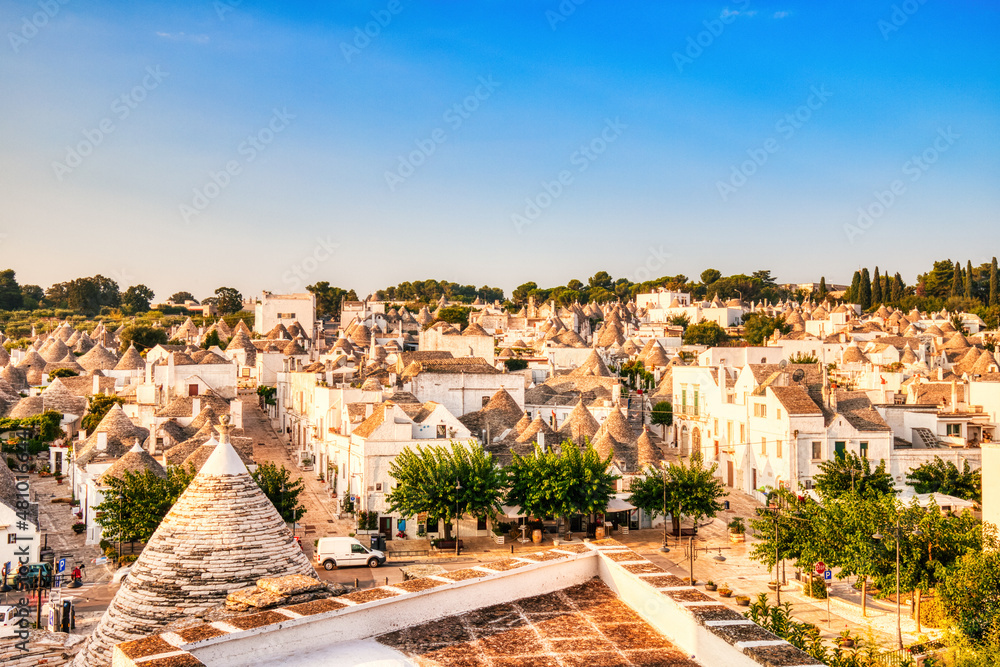 Aerial View of the Trulli Houses during a Sunrise with Bright Blue Sky in Alberobello, Puglia