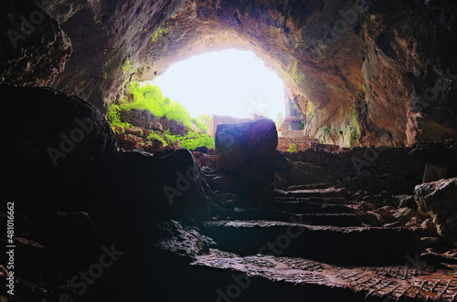Obraz na plátně Wide-angle landscape view of mysterious cave and Meryem Ana Church