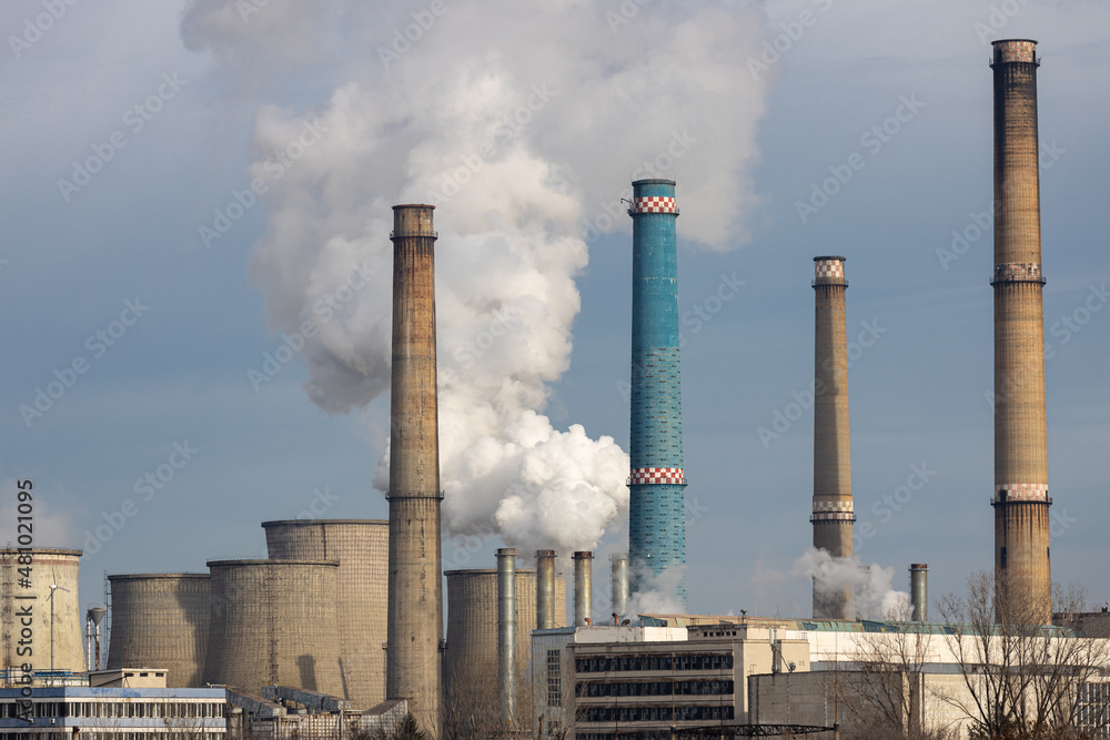 Thermal power station in Bucharest, Romania. The factory chimney is polluting the atmosphere. Thermal power station in Bucharest, Romania. The factory chimney is polluting the atmosphere.